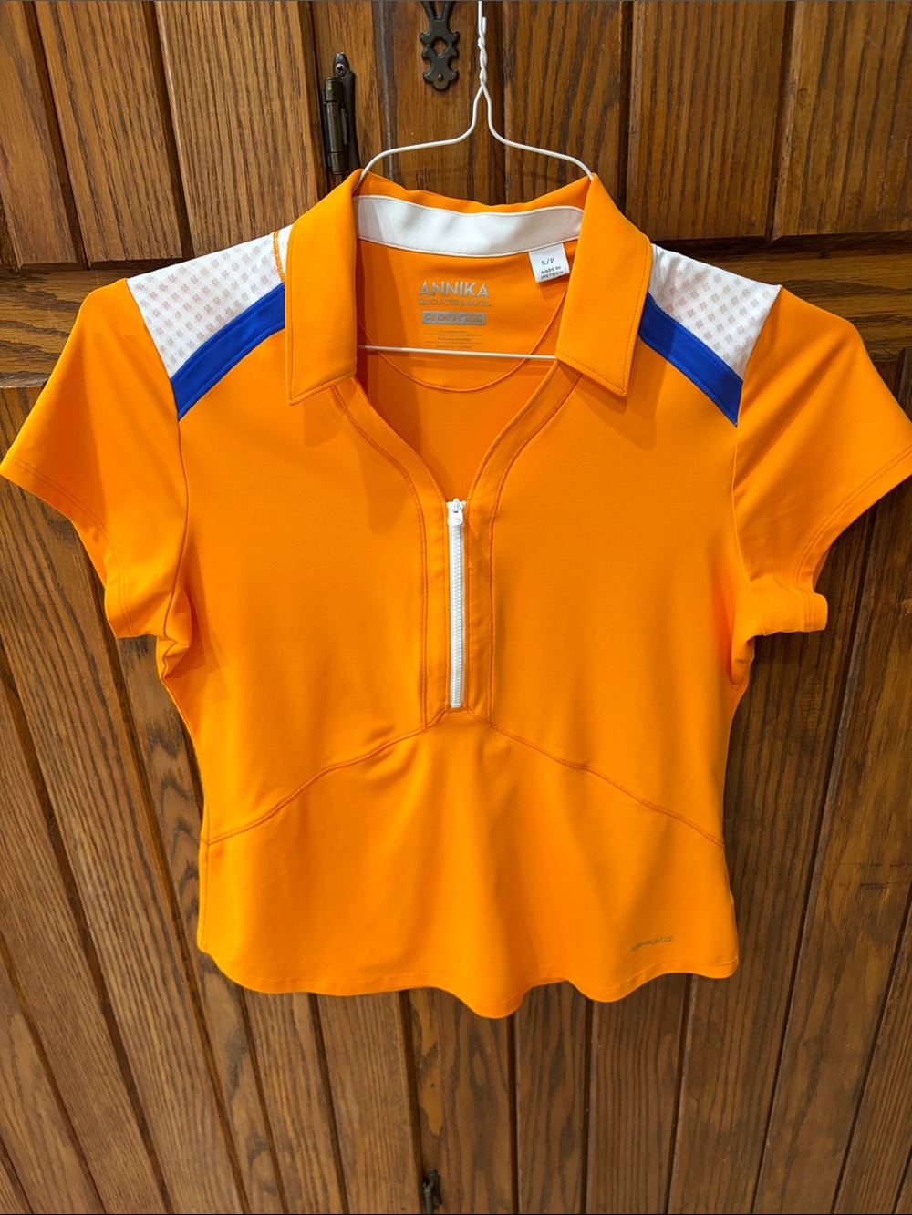 Annika Bright Orange Short Sleeve Zip Blue & White Accents
Size small petite